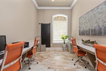Chic business center with stylish orange chairs, modern desks, and elegant decor, ideal for productivity and inspiration.