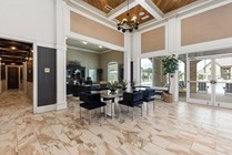 Luxurious lobby featuring elegant marble flooring, modern furniture, and a welcoming reception area with views of the outdoor pool.