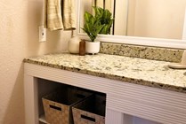 Experience elegance with this modern bathroom vanity, featuring a granite countertop and chic decor.