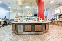 Explore the vibrant design of this modern cafeteria, offering a welcoming dining atmosphere.