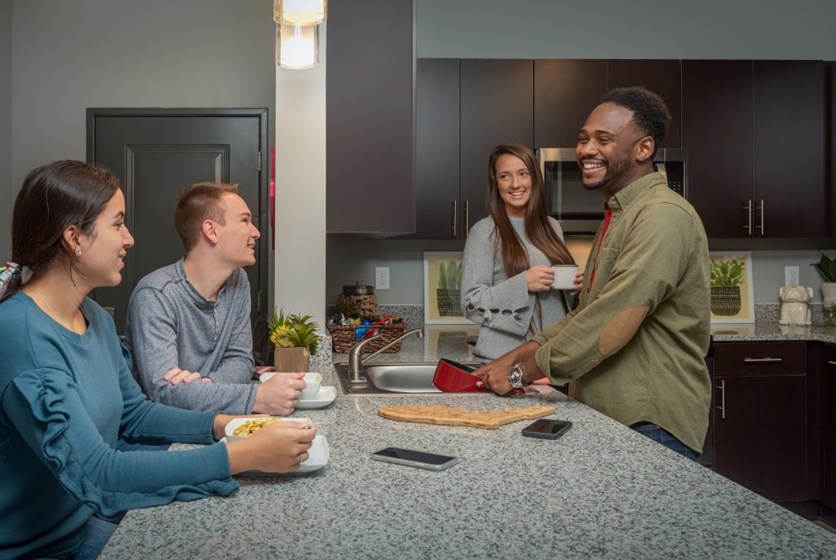 Socializing with Other Residents Friends spending time together at their Off Campus Apartment